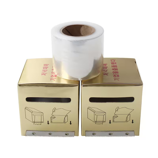 Gold box with a roll of paper on top against a white background